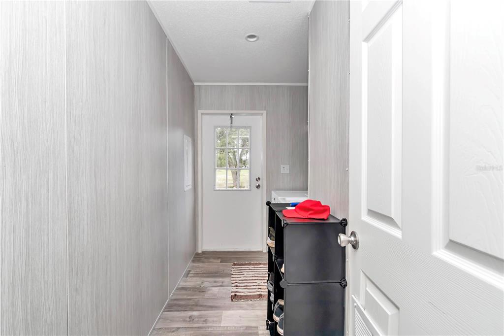 5190 Southwest 178th Terrace Dunnellon, FL 34432 - Photo 34 of 51 a hallway with a potted plant on a counter next to a window