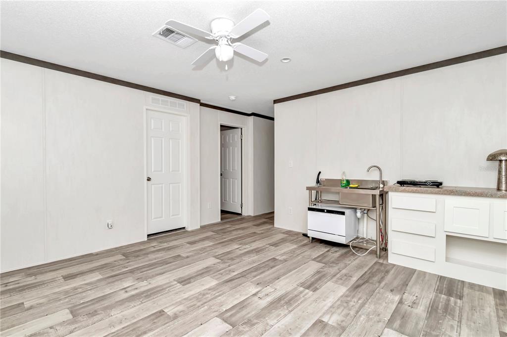 5190 Southwest 178th Terrace Dunnellon, FL 34432 - Photo 38 of 51 a room with a bed and a chandelier
