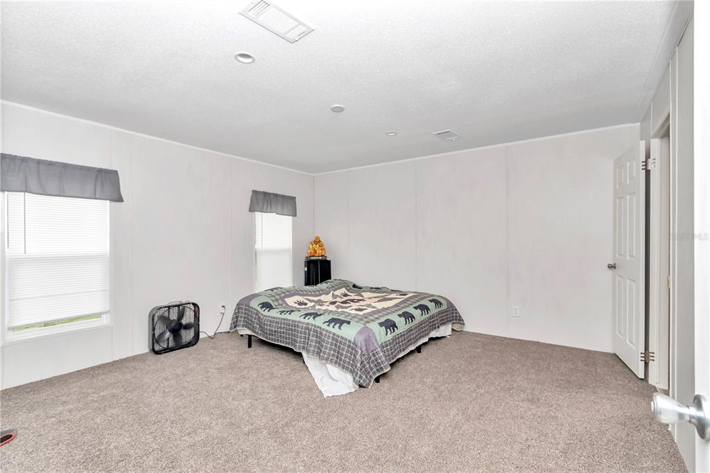 5190 Southwest 178th Terrace Dunnellon, FL 34432 - Photo 42 of 51 a spacious bedroom with a bed and a window