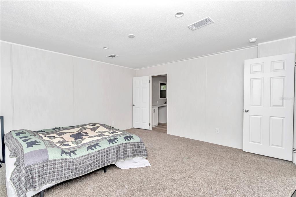 5190 Southwest 178th Terrace Dunnellon, FL 34432 - Photo 44 of 51 a bedroom with a bed and a painting on the wall