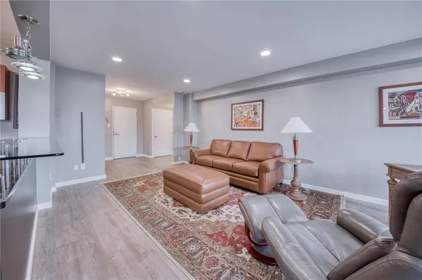 a living room with furniture and a rug