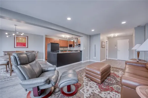 a living room with furniture and a kitchen