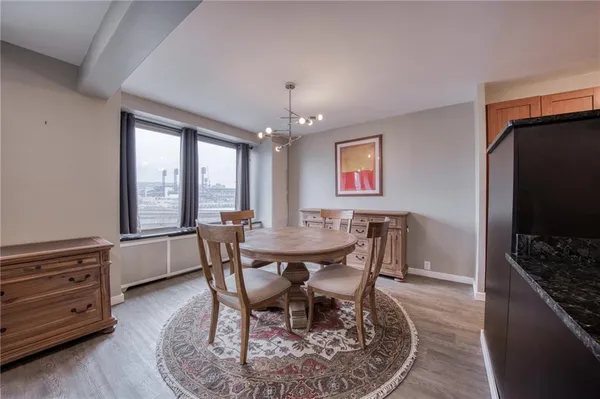 a view of a dining room with furniture and chandelier