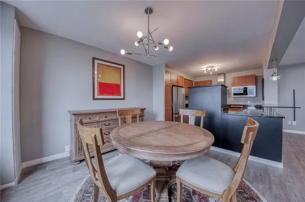 a view of a dining room with furniture wooden floor and chandelier