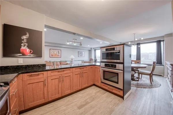 a kitchen with stainless steel appliances granite countertop a stove top oven a sink with granite countertops and cabinets