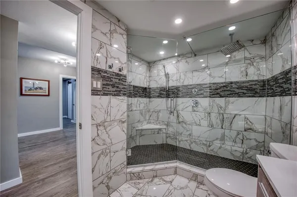 a bathroom with a toilet sink and shower
