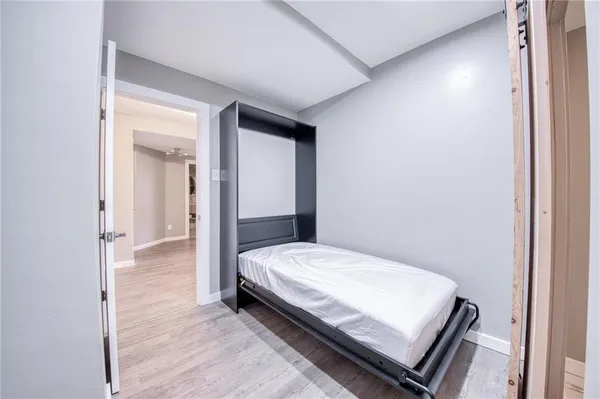 a bedroom with a bed and wooden floor