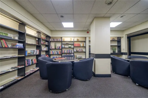 a living room with a couch and bookshelf