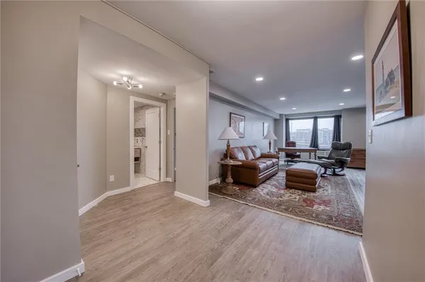 a living room with furniture and a wooden floor