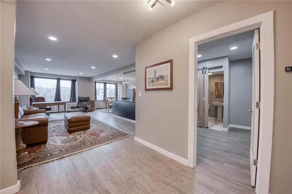 a living room with furniture and a wooden floor