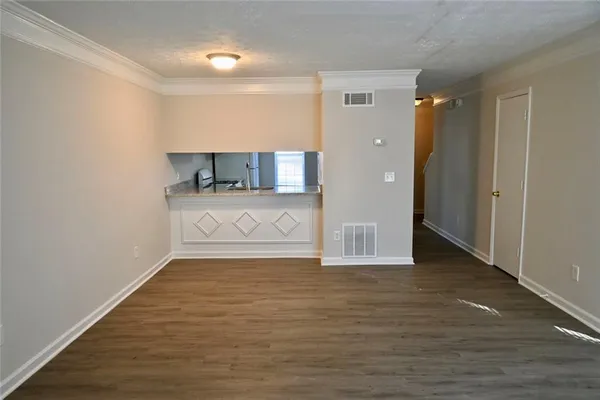 a view of a room with wooden floor and cabinet