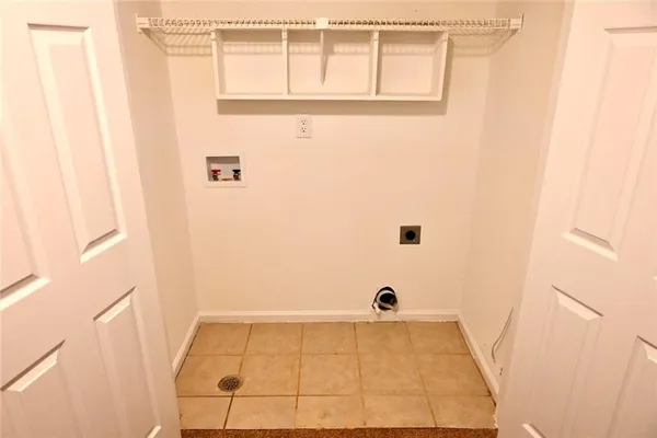 a view of a brick house with a large windows and a large tree