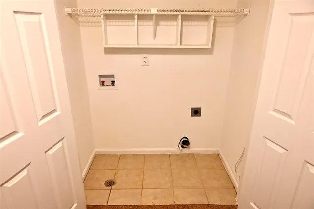 a view of a brick house with a large windows and a large tree