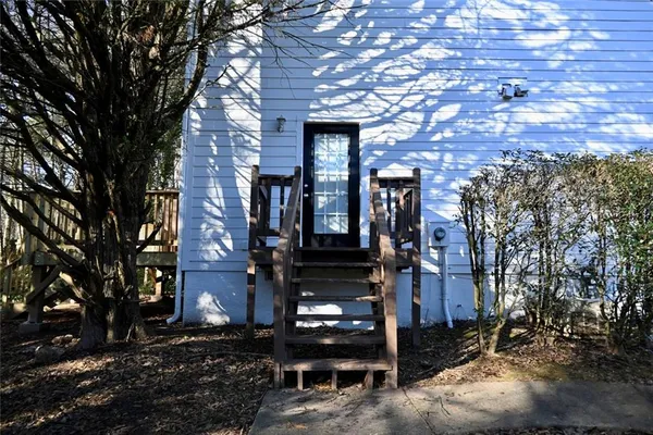 a view of balcony with wooden floor and fence