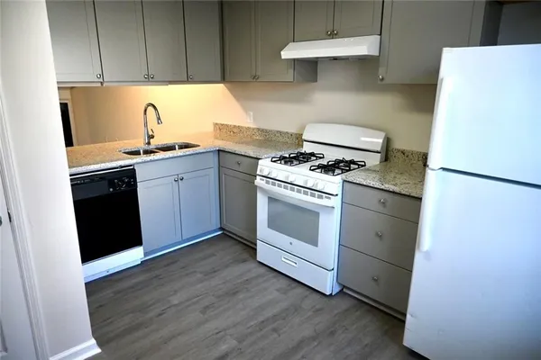 a kitchen with a stove and a refrigerator