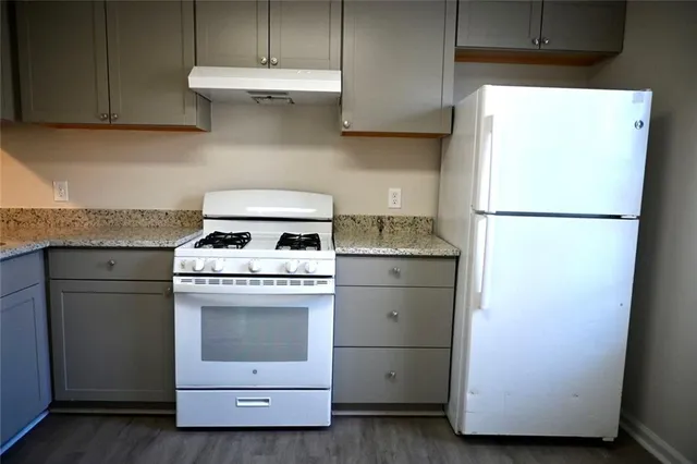 a kitchen with a stove and a refrigerator