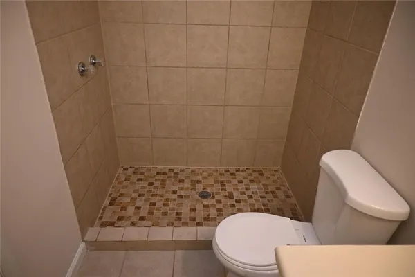 a white toilet sitting next to a bathroom sink
