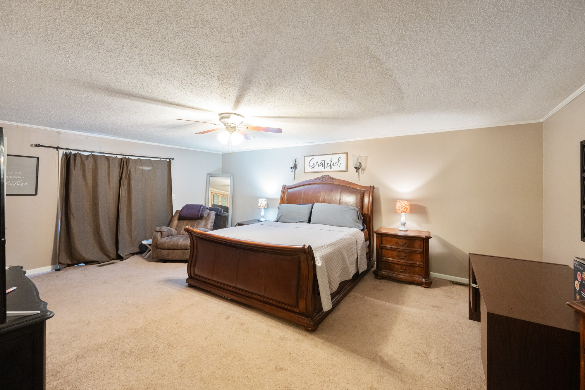 300 Buena Vista Road Huntingdon, TN 38344 - Photo 11 of 23 a bedroom with a bed and a chandelier