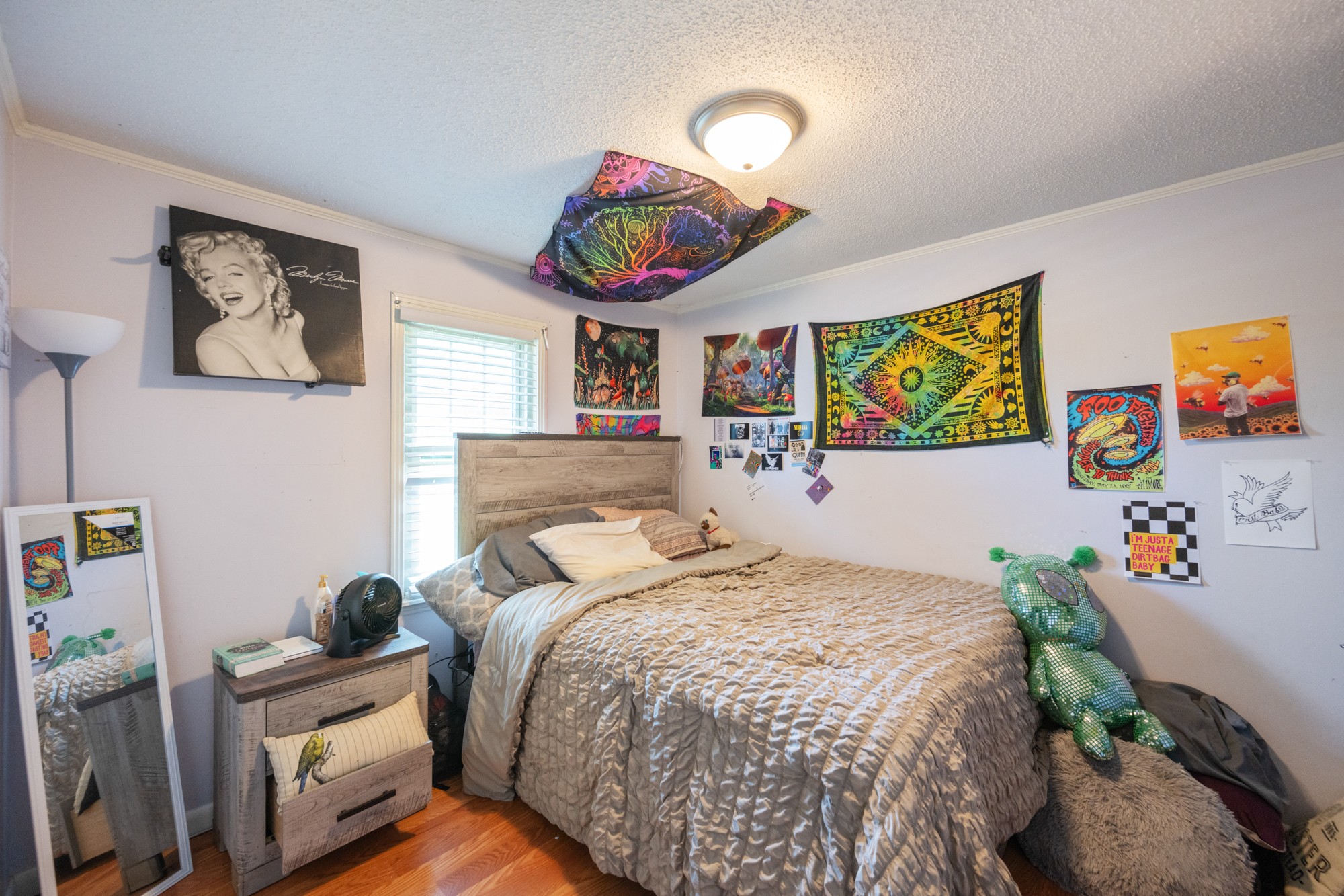 300 Buena Vista Road Huntingdon, TN 38344 - Photo 13 of 23 a bedroom with a bed and dresser with wooden floor