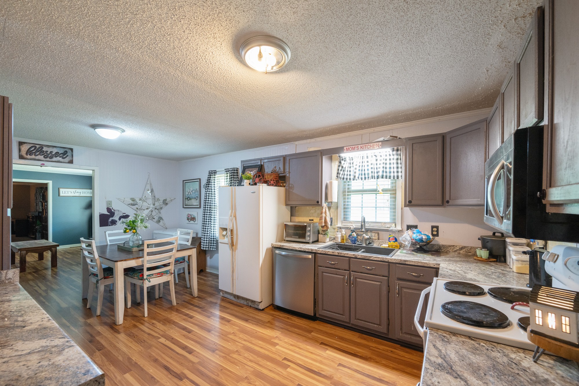 300 Buena Vista Road Huntingdon, TN 38344 - Photo 6 of 23 a kitchen with stainless steel appliances kitchen island granite countertop a refrigerator and a stove top oven