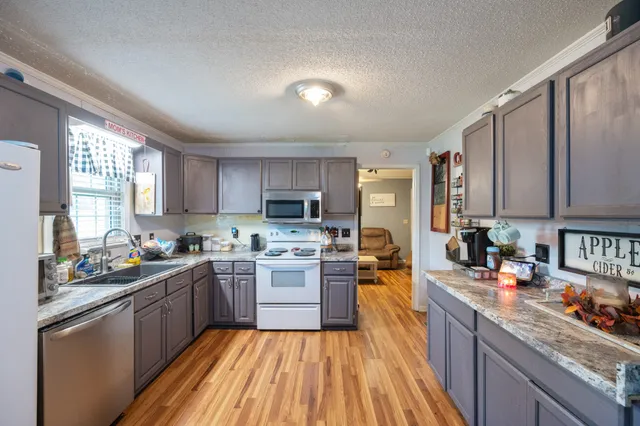 a kitchen with lots of counter top space a sink and appliances