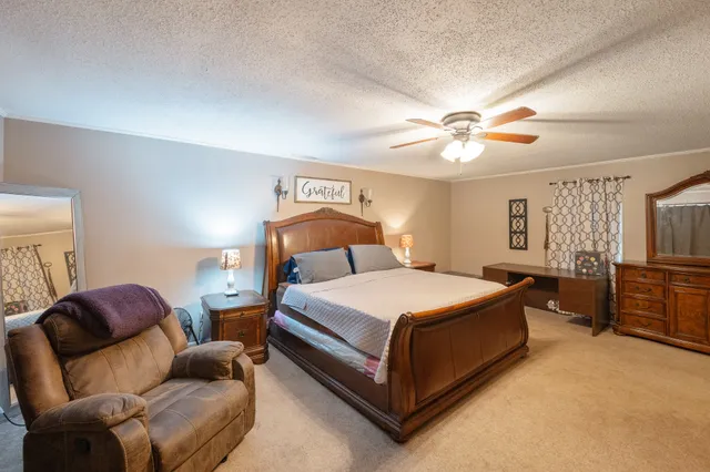 a bedroom with a bed couch and window