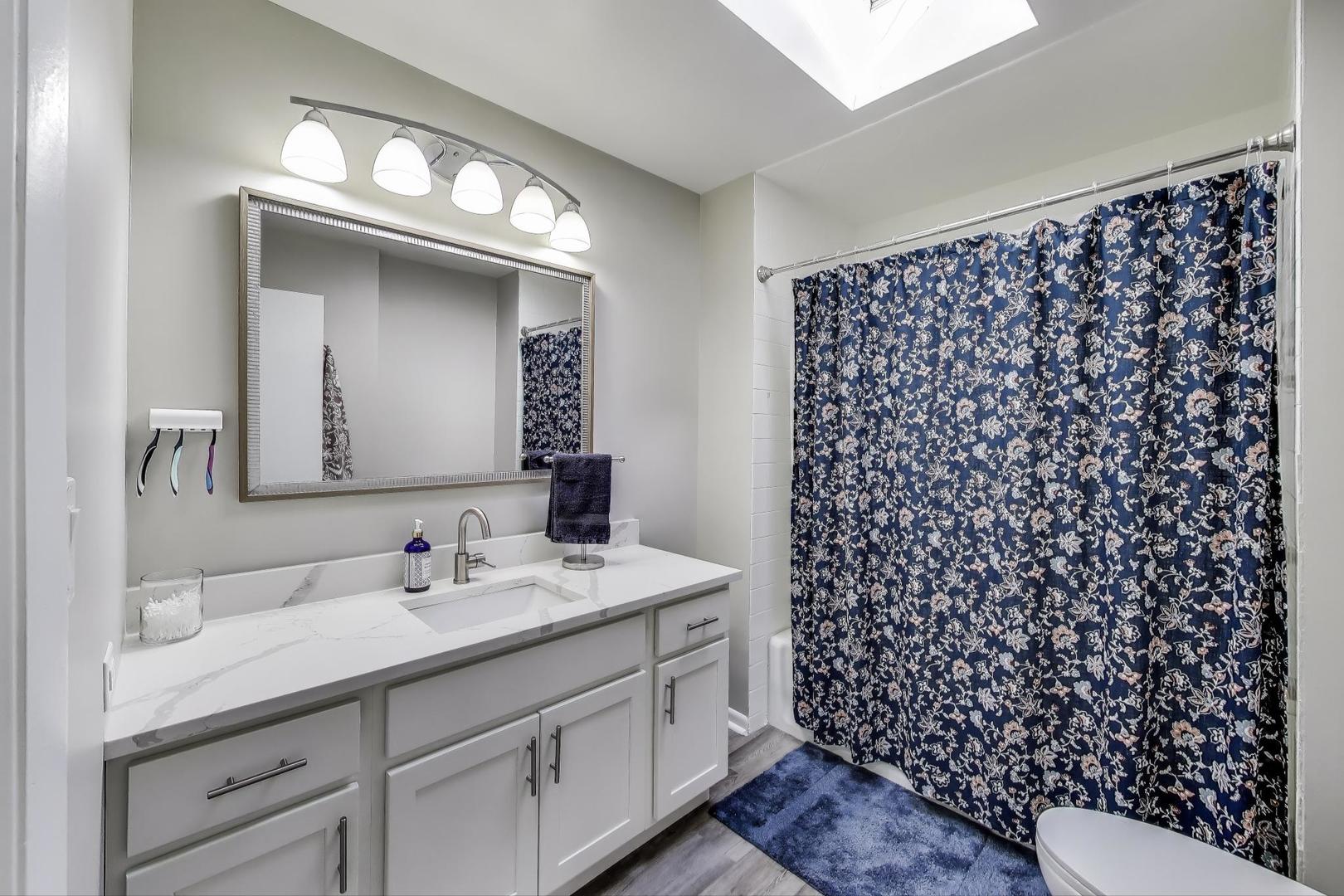 3600 Owl Drive Rolling Meadows, IL 60008 - Photo 13 of 21 a bathroom with a sink a toilet a shower and a mirror