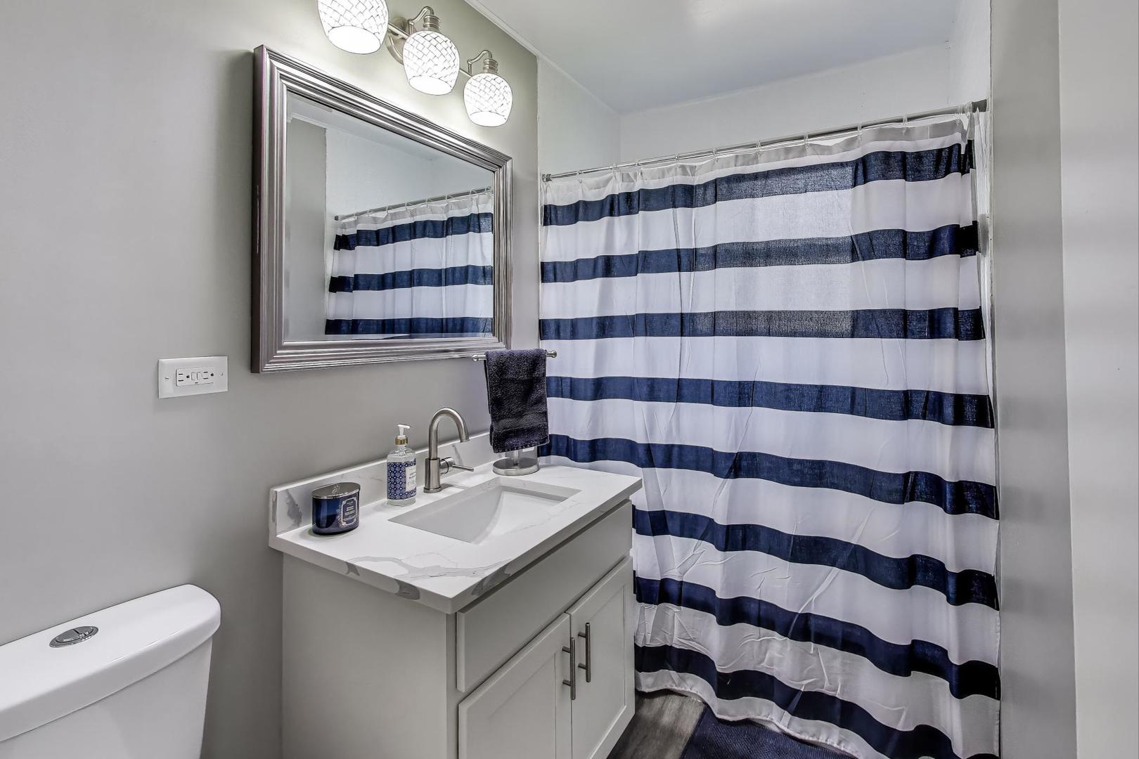 3600 Owl Drive Rolling Meadows, IL 60008 - Photo 8 of 21 a bathroom with a sink a toilet a large mirror and shower curtain