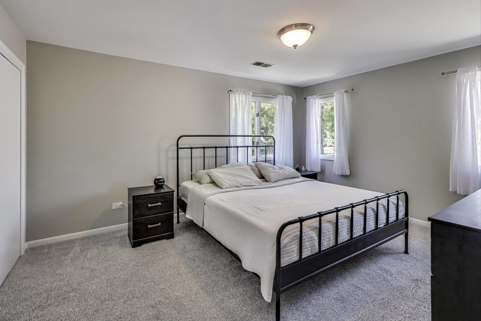 3600 Owl Drive Rolling Meadows, IL 60008 - Photo 9 of 21 a bed sitting in a bedroom next to a window