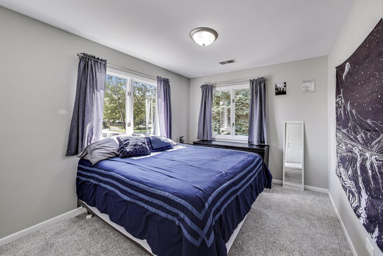 3600 Owl Drive Rolling Meadows, IL 60008 - Photo 10 of 21 a bed sitting in a spacious bedroom next to a window