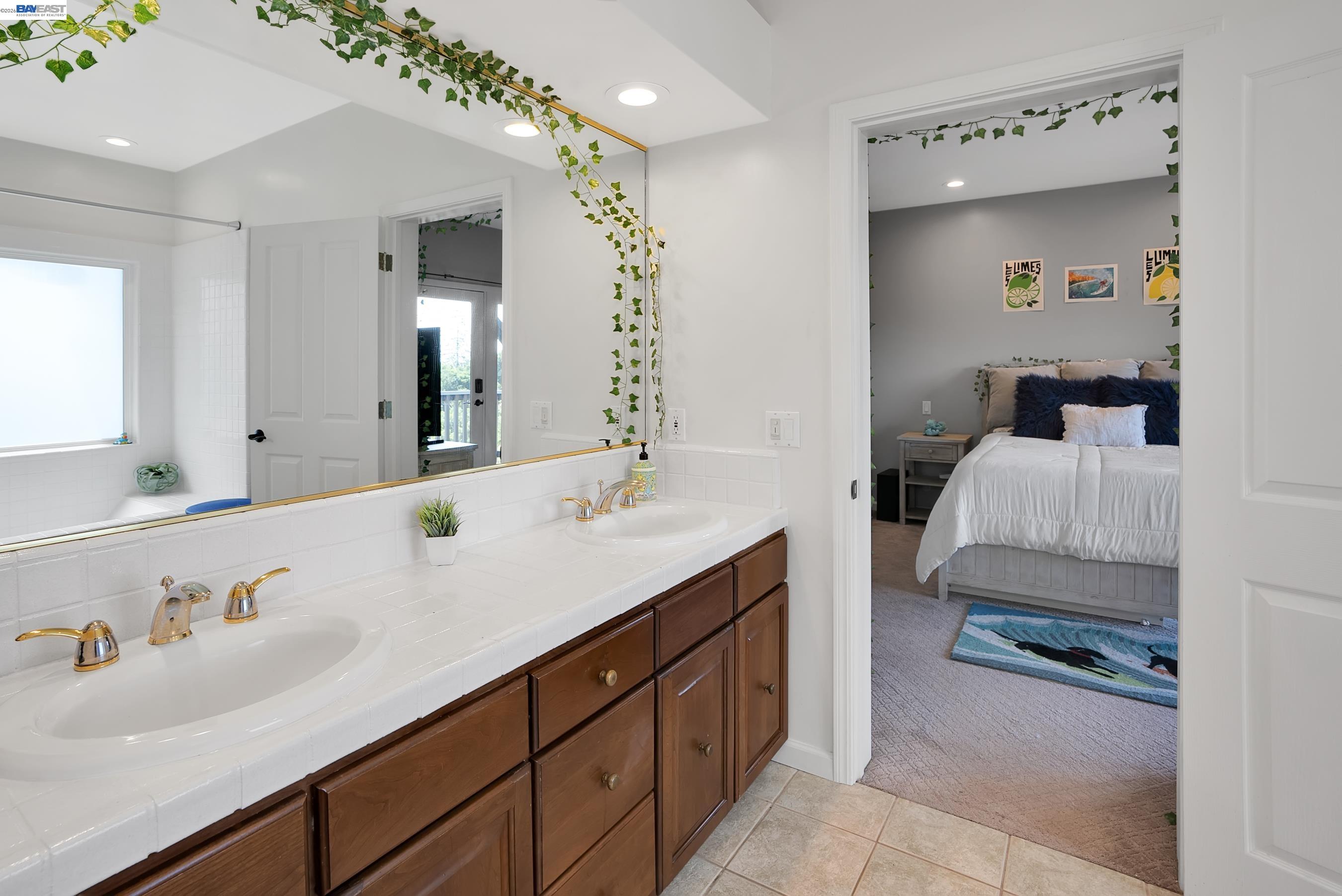 905 Moon Valley Ranch Road Watsonville, CA 95076 - Photo 40 of 60 a en suite bathroom with a double vanity sink and a mirror