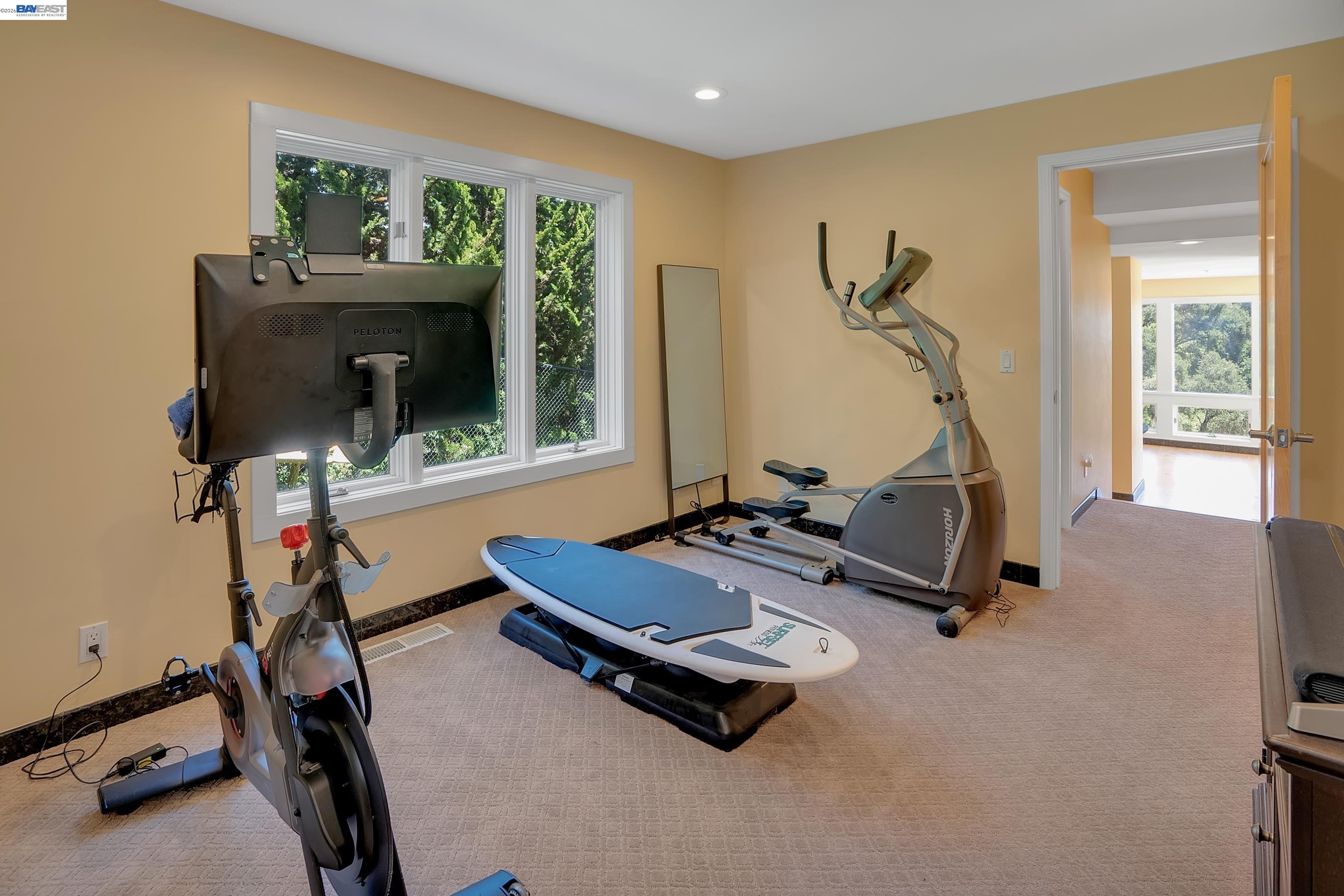 905 Moon Valley Ranch Road Watsonville, CA 95076 - Photo 46 of 60 a room with gym equipment and a flat screen tv