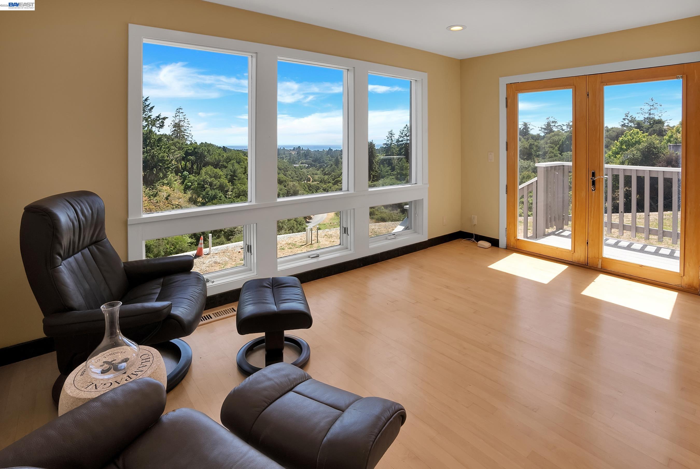 905 Moon Valley Ranch Road Watsonville, CA 95076 - Photo 49 of 60 a living room with furniture and a floor to ceiling window