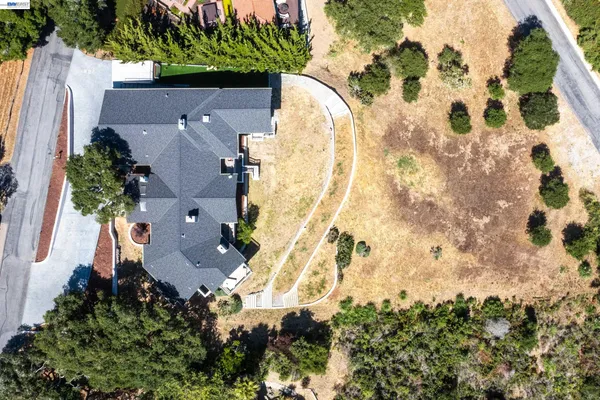 a view of a house with a sink and yard with swimming pool and patio