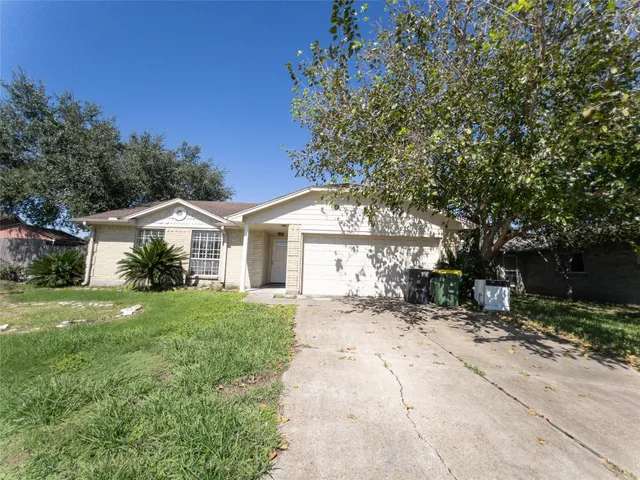 a front view of a house with a yard and trees