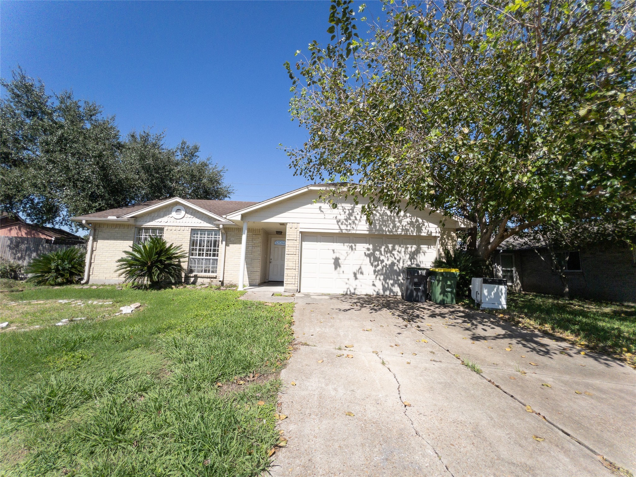 a front view of a house with a yard and trees