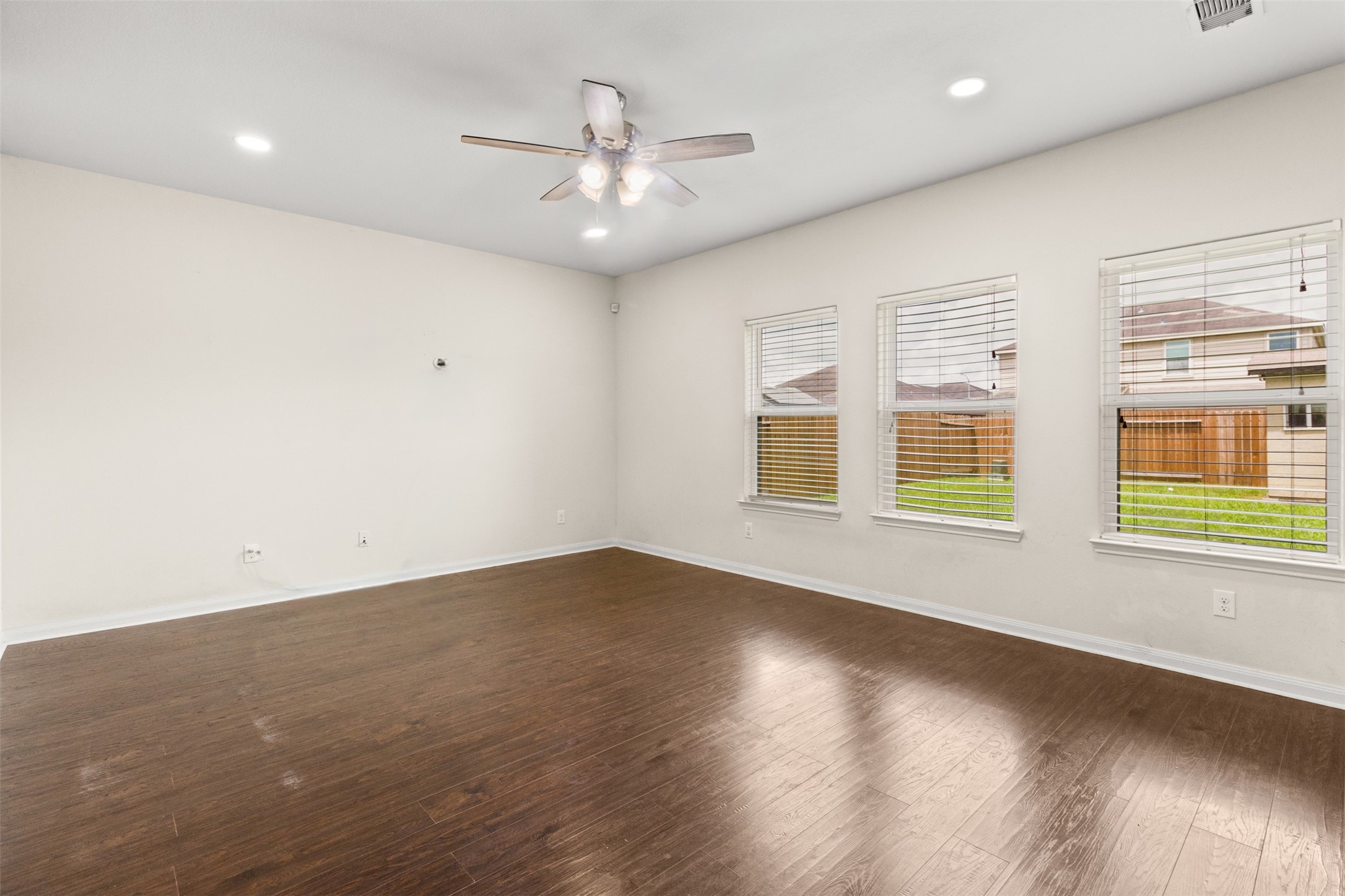 9426 Grand Spark Drive Rosharon, TX 77583 - Photo 6 of 31 Rich flooring, abundant natural light, and a neutral color palette create a comfortable gathering space ready for movie nights, game days, and family celebrations.