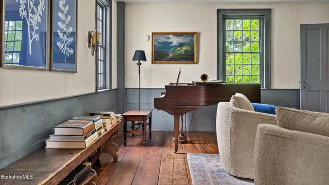 a bedroom with a bed a bookshelf and a window
