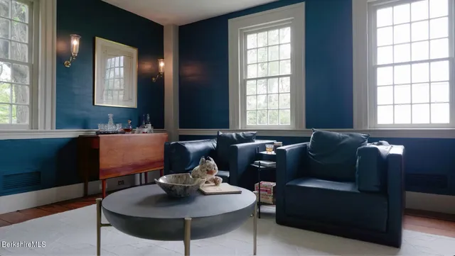 a living room filled with furniture and a large window