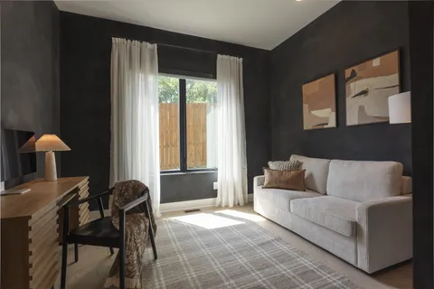 a bathroom with a sink double vanity granite tub shower and a mirror