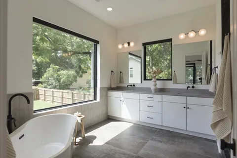 a bathroom with a double vanity sink and a mirror