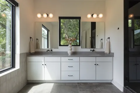 a bathroom with a double vanity sink and a mirror