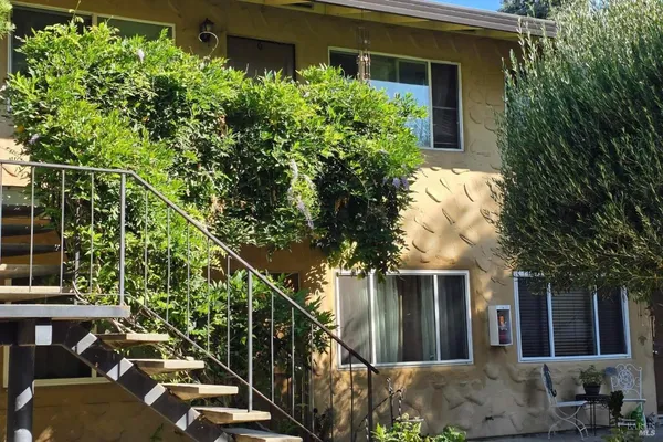 a view of a house with a tree