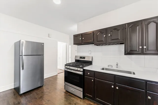 a kitchen with a refrigerator and a sink