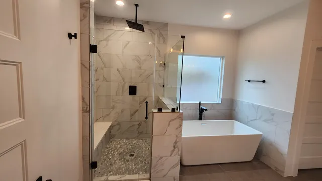 a en suite bathroom with a granite countertop sink a toilet a mirror and shower