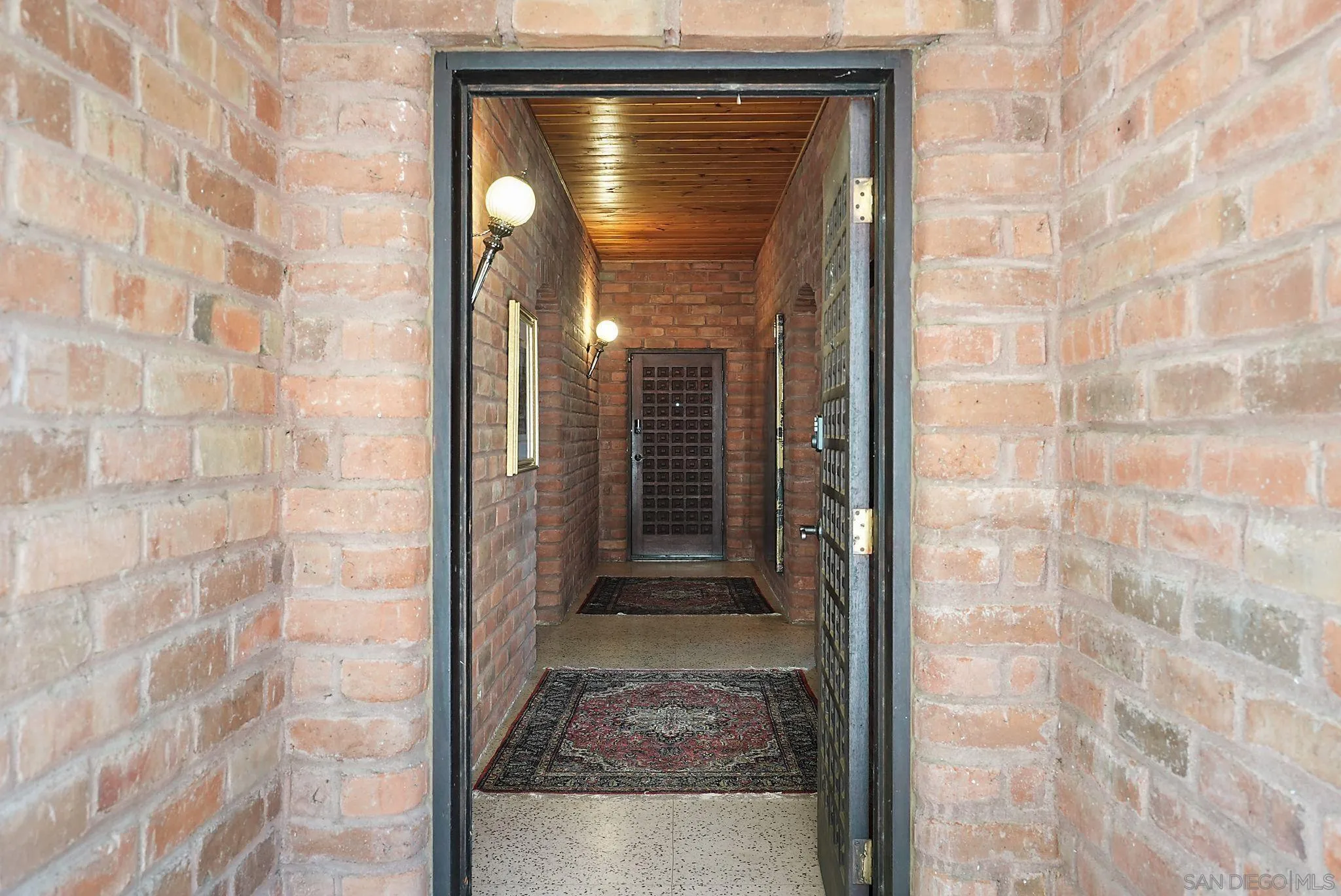 14740 Willow Road Lakeside, CA 92040 - Photo 5 of 37 a view of a wooden door with a brick wall
