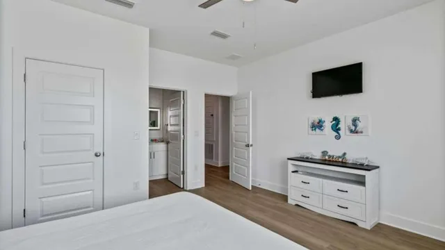 a bedroom with a bed and a flat screen tv