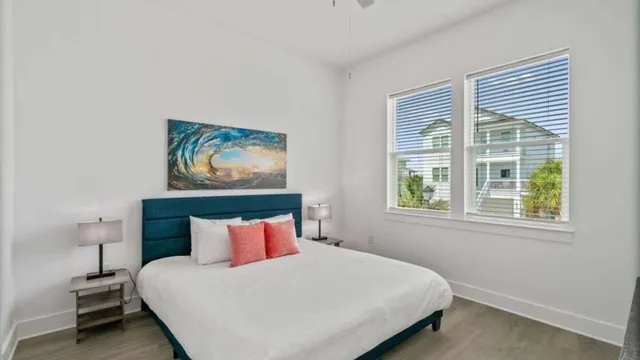 a bedroom with a bed and a painting on the wall