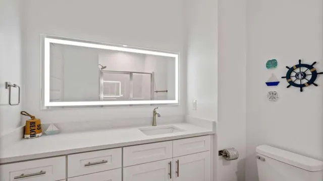 a bathroom with a sink a light fixture and a toilet