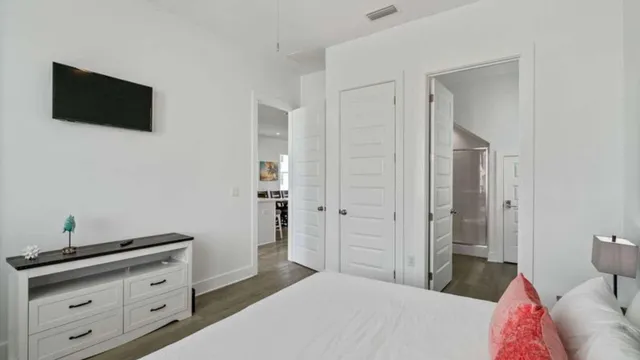 a bedroom with a bed and a flat screen tv